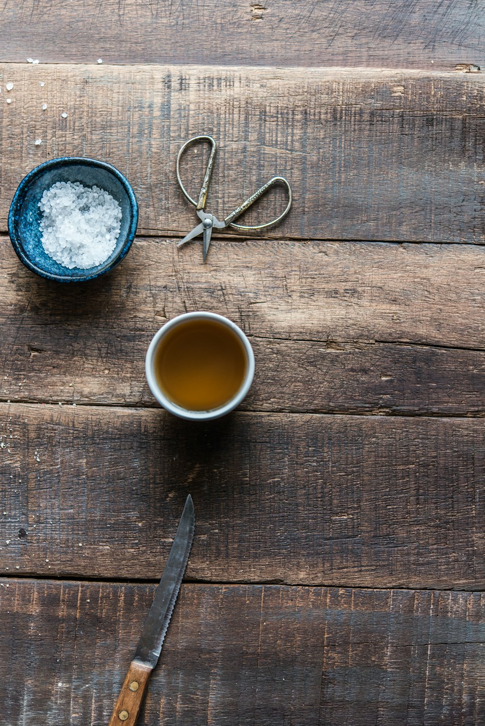 a cup of tea next to a pair of scissors