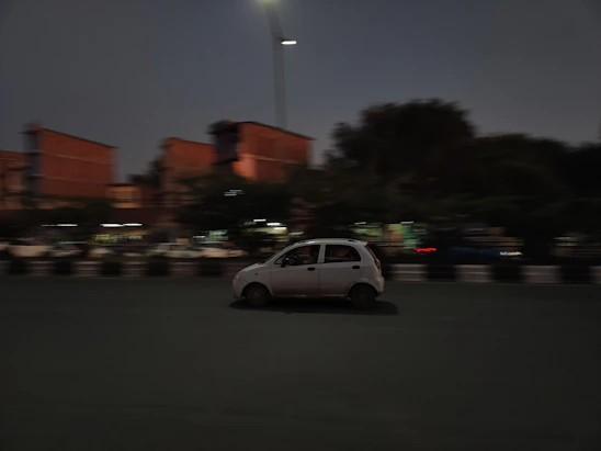 Blurred city lights and a speeding car illustrating fast movement.