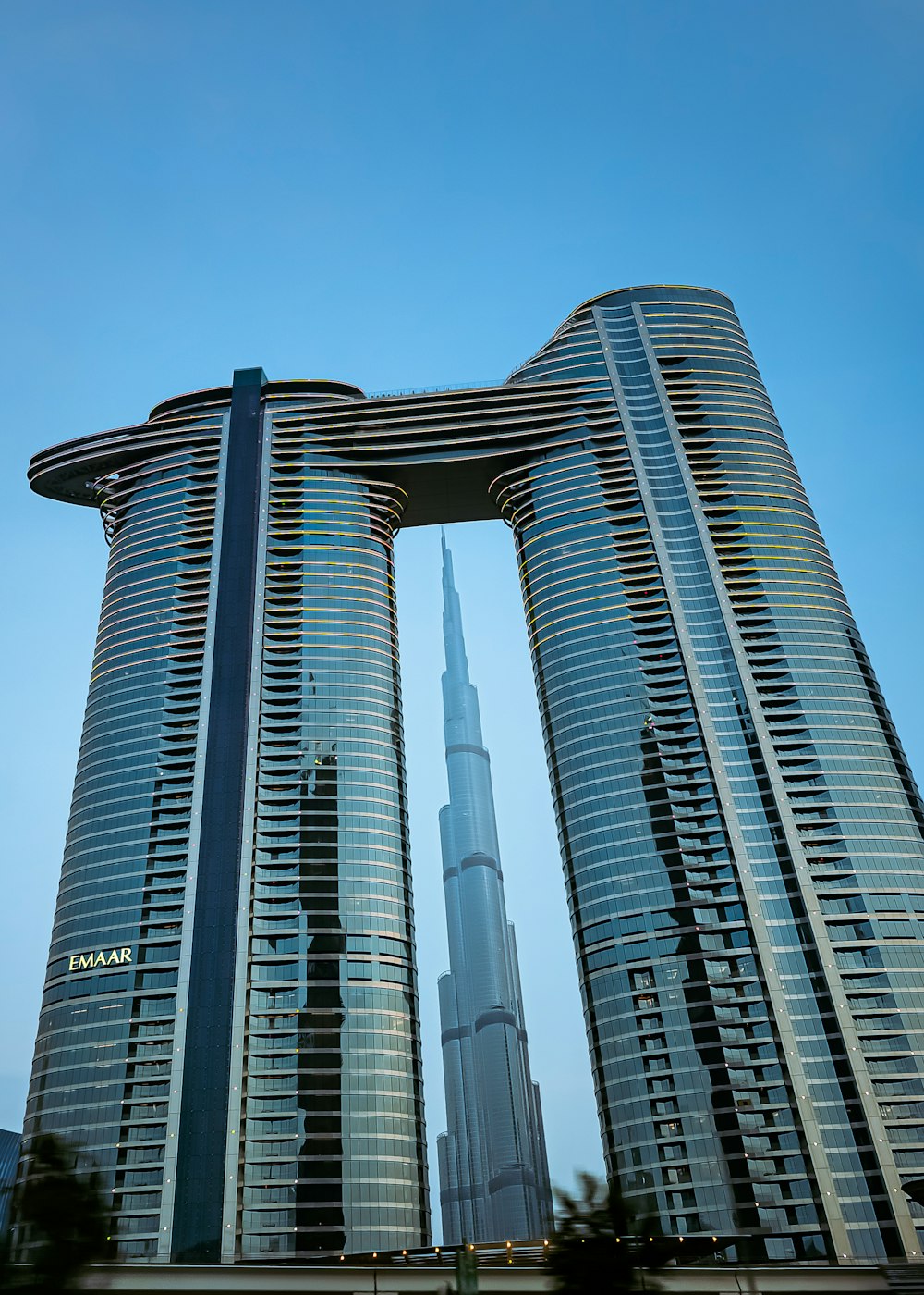 a couple of tall buildings with a sky background