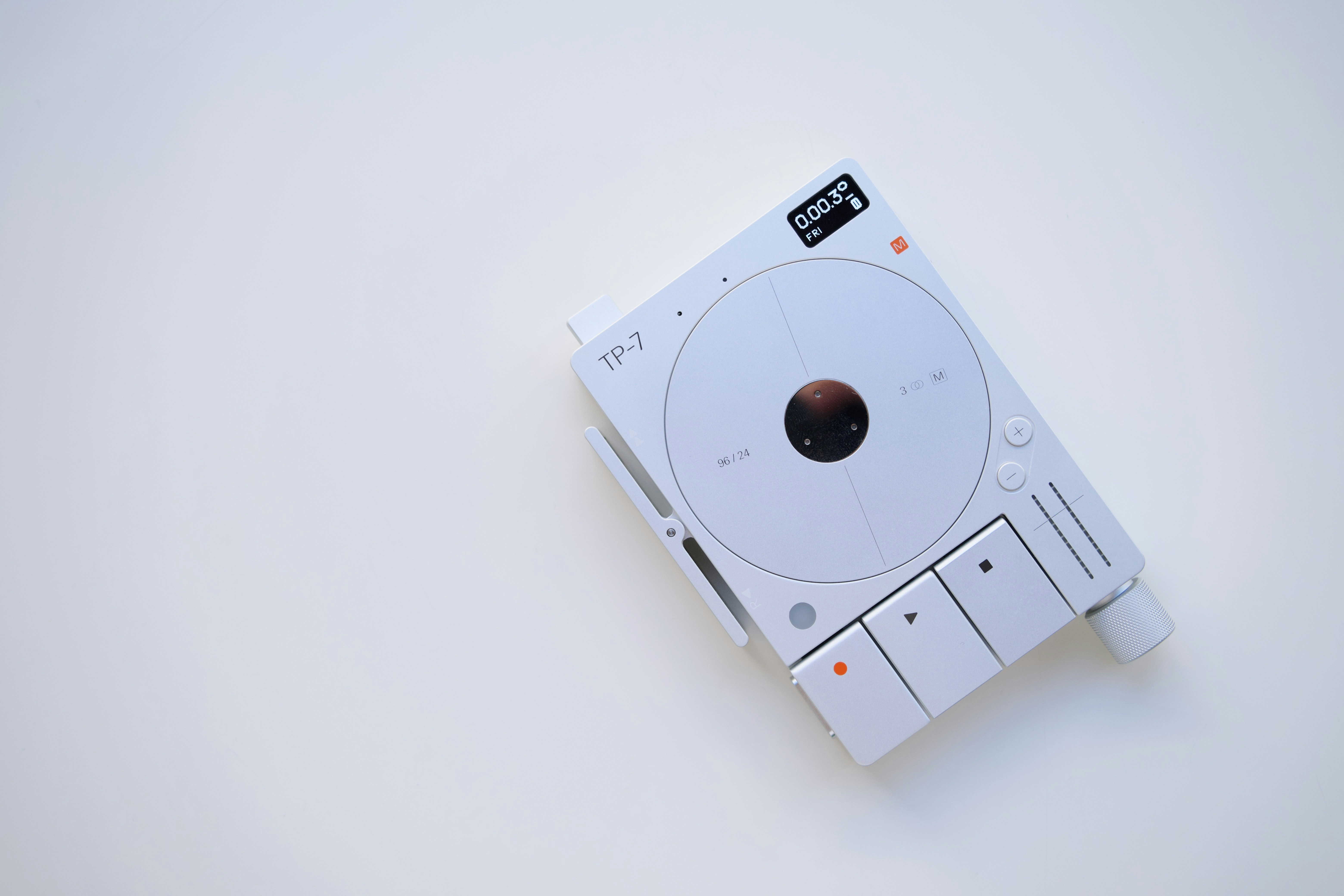 a close up of a white electronic device on a white surface