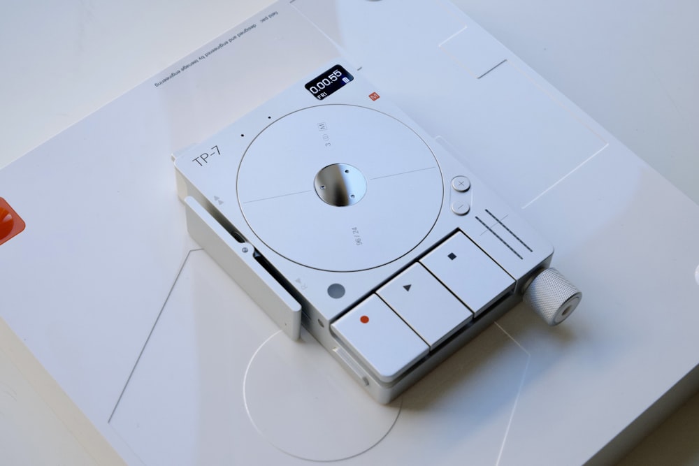 a white cd player sitting on top of a table