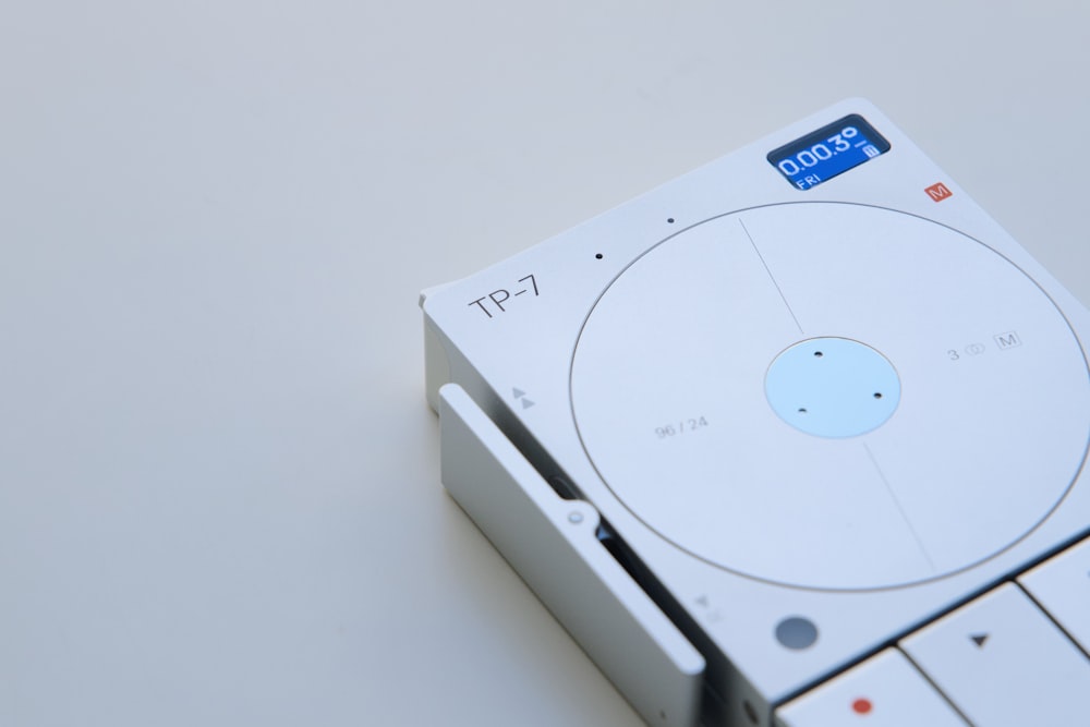 a white cd player sitting on top of a table