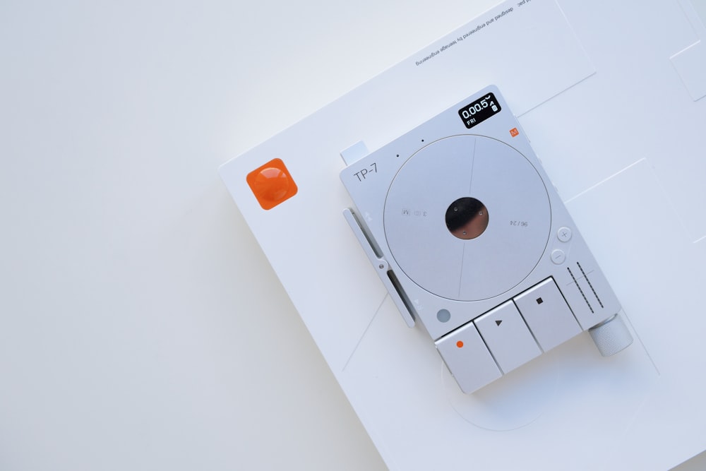 a white electronic device sitting on top of a white table