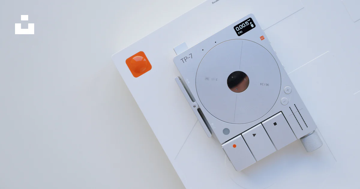 A white electronic device sitting on top of a white table photo – Free ...