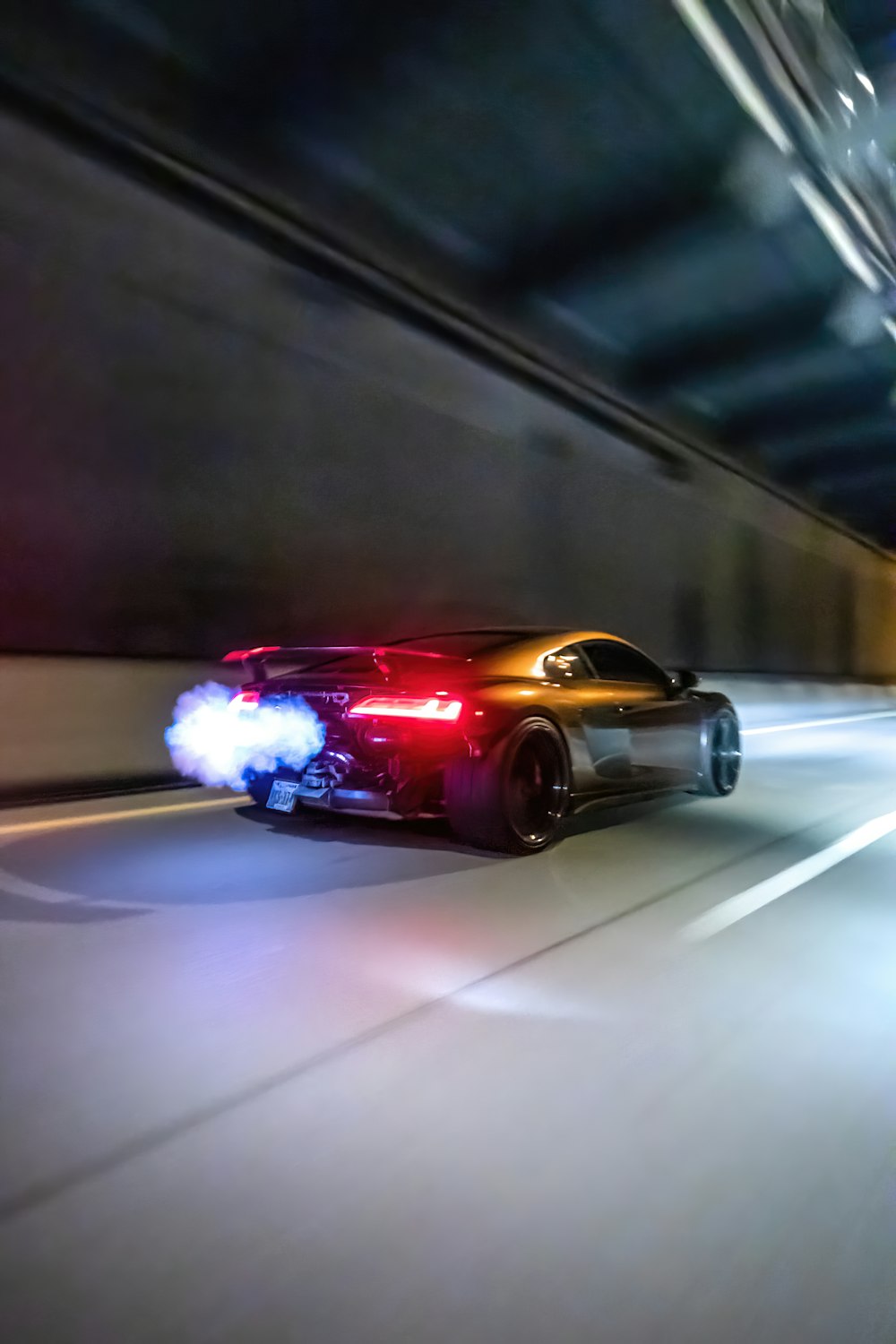 a car driving through a tunnel with a police light on