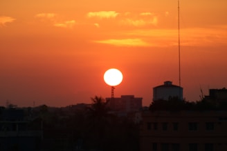 A vibrant sunset over a bustling urban landscape.