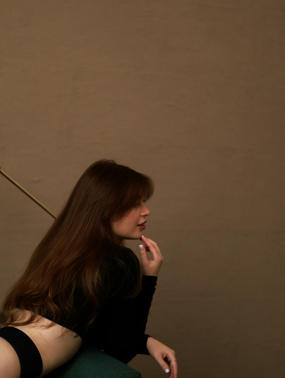 a woman sitting on a chair smoking a cigarette