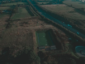 An aerial view of a completed outdoor sports ground surrounded by greenery.