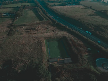 An aerial view of a completed outdoor sports ground surrounded by greenery.