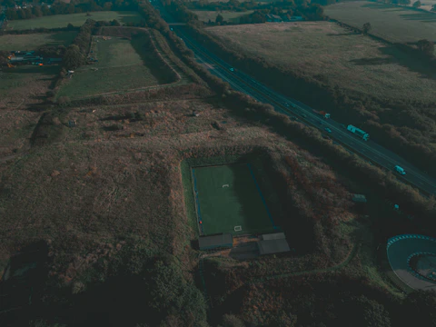 A wide-angle photo capturing Aarnaa training intensely on a lush emerald green field.