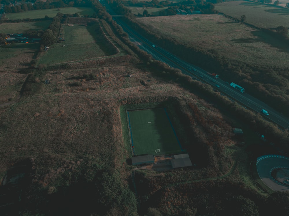 an aerial view of a soccer field and a highway