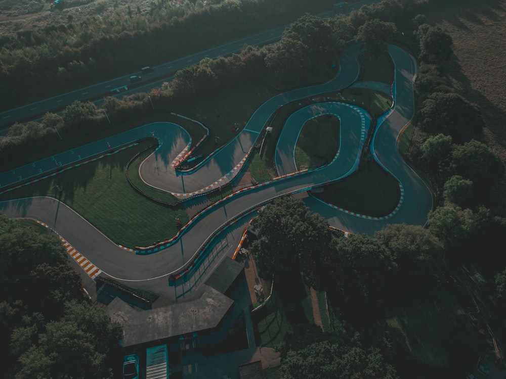 an aerial view of a curved road in a park