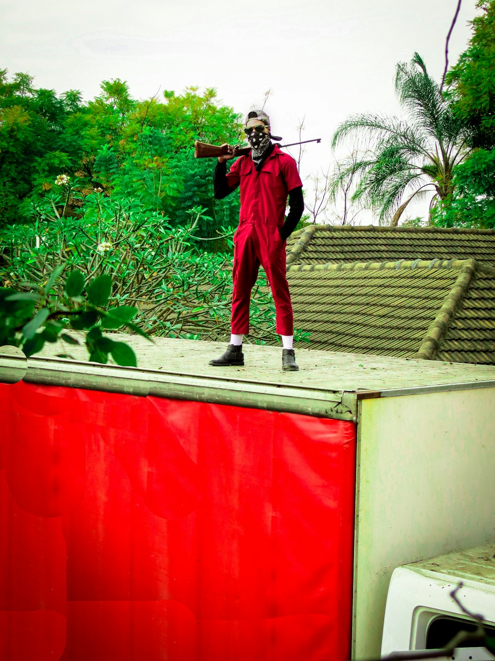 a man in a clown costume standing on a wall