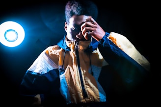 A vibrant shot of a Lumina Apparel windbreaker catching the light during an early morning jog in the park.