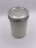 A glass jar with a metal lid, filled with a white substance, sits on a light background. The jar has a textured design that gives it an intricate appearance.
