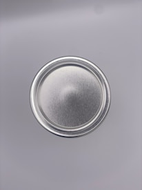 Frosted glass container with a sharp metallic silver rim showcasing a memecoin project cover.