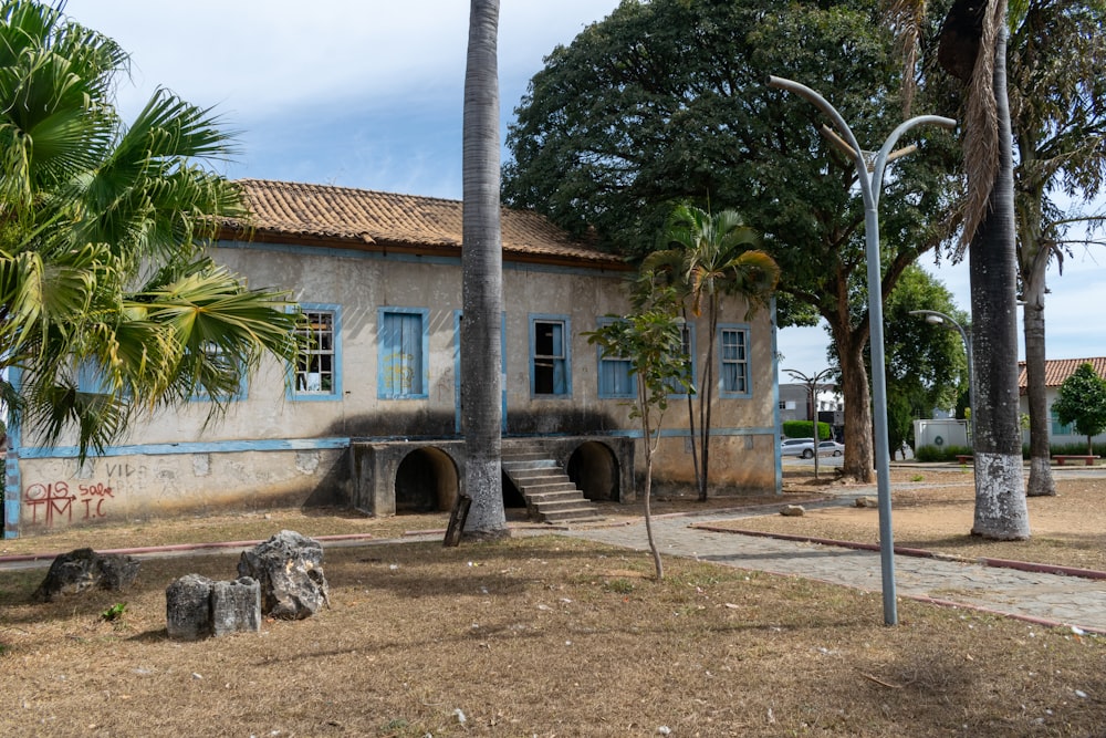 an old building with palm trees in front of it