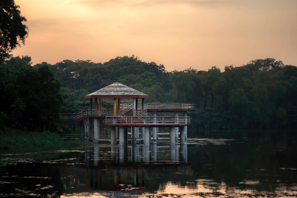 a small wooden structure sitting on top of a body of water