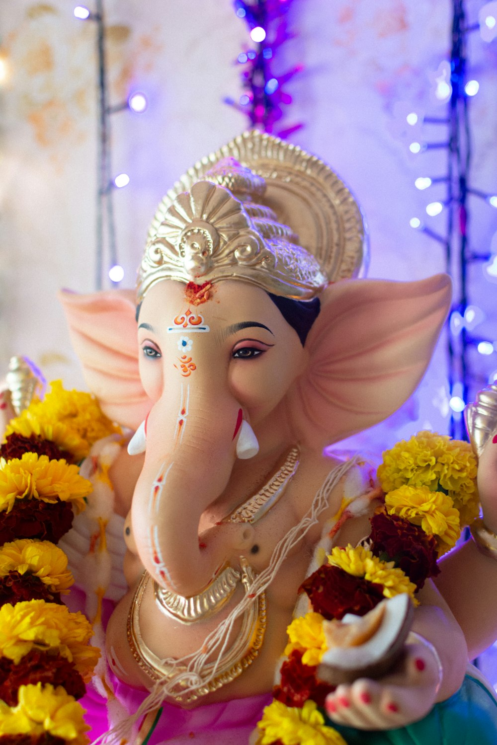 a statue of an elephant with flowers in its trunk