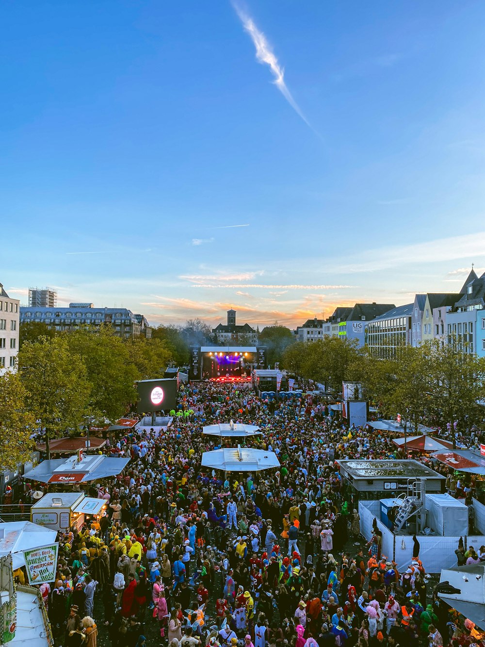 a large crowd of people standing around tents