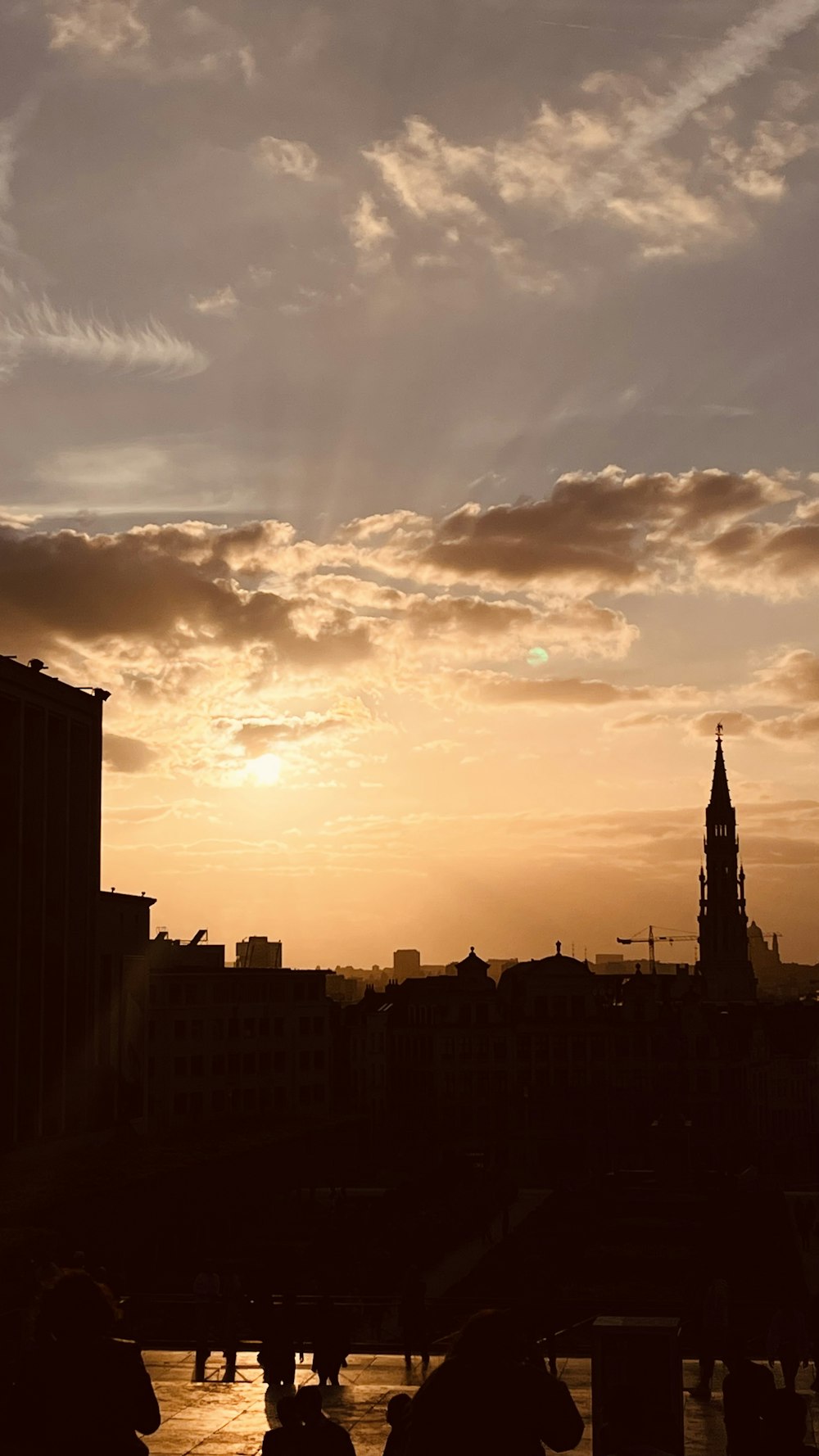 the sun is setting over a city with tall buildings