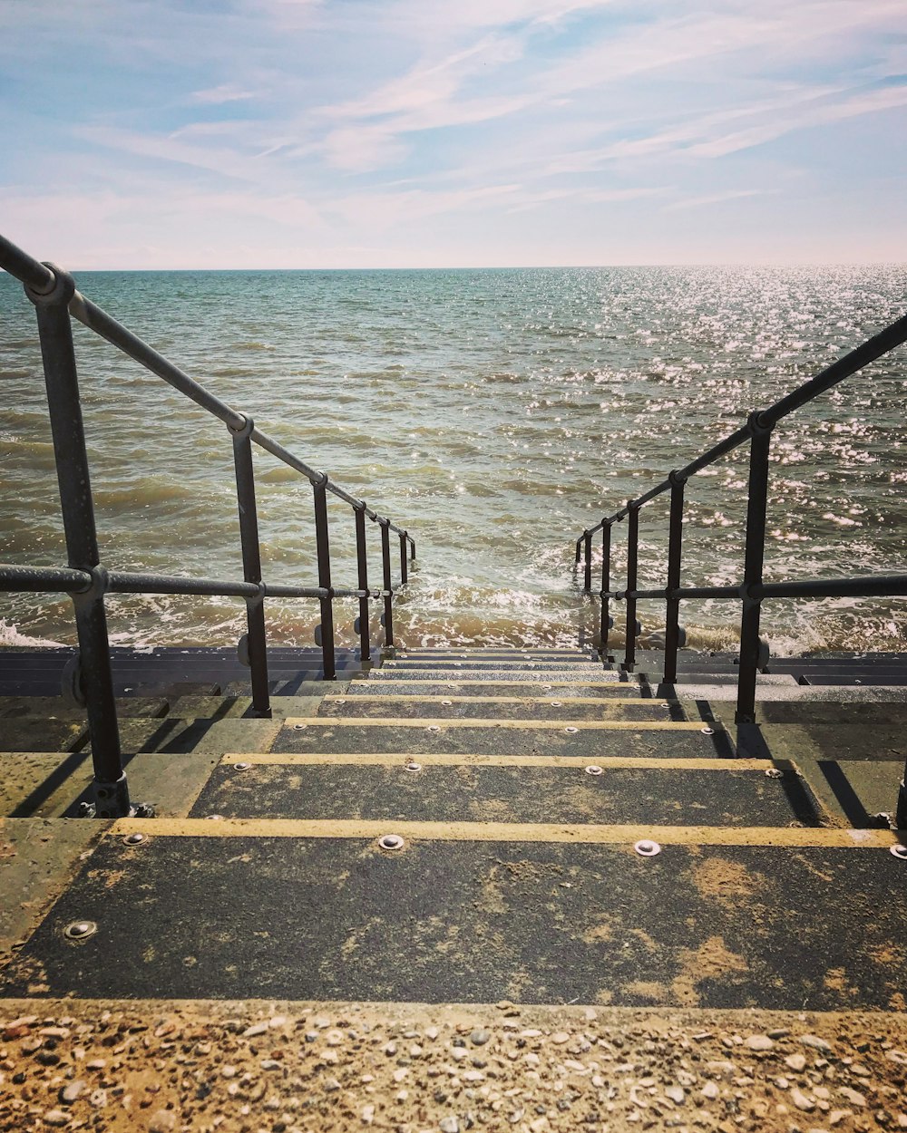 a set of stairs leading down to the ocean