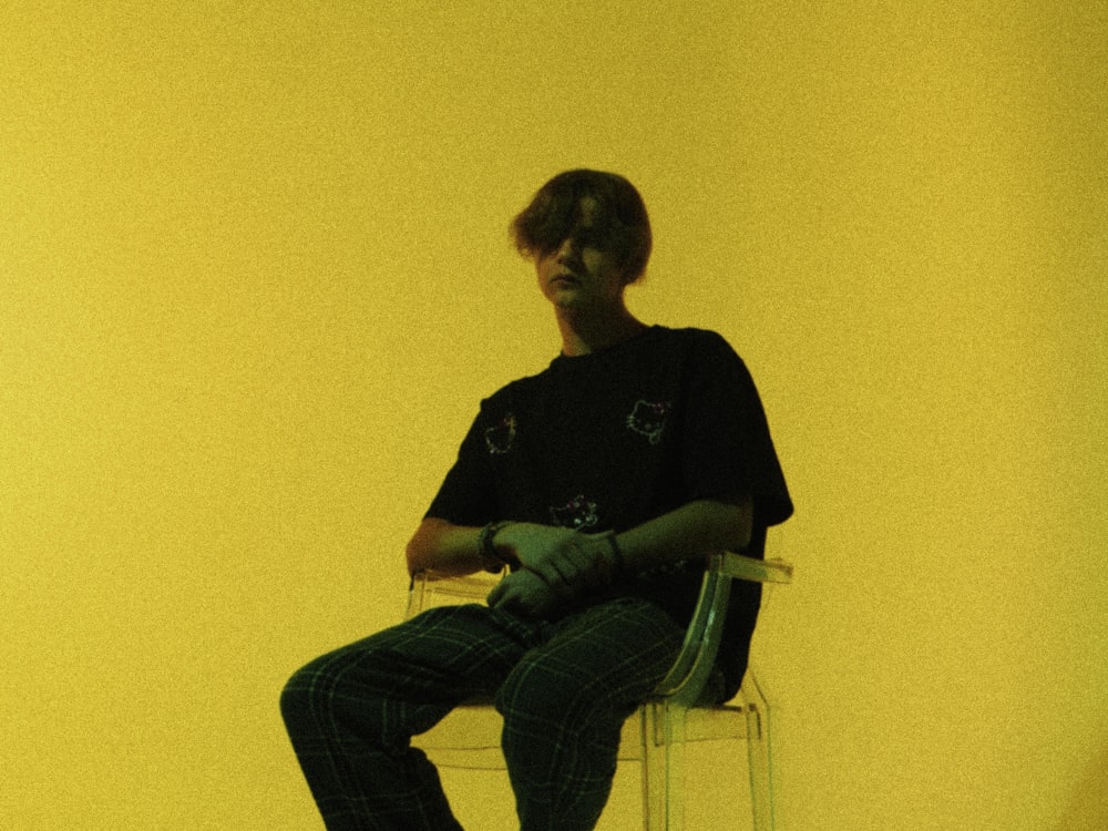 a man sitting on a chair in a room