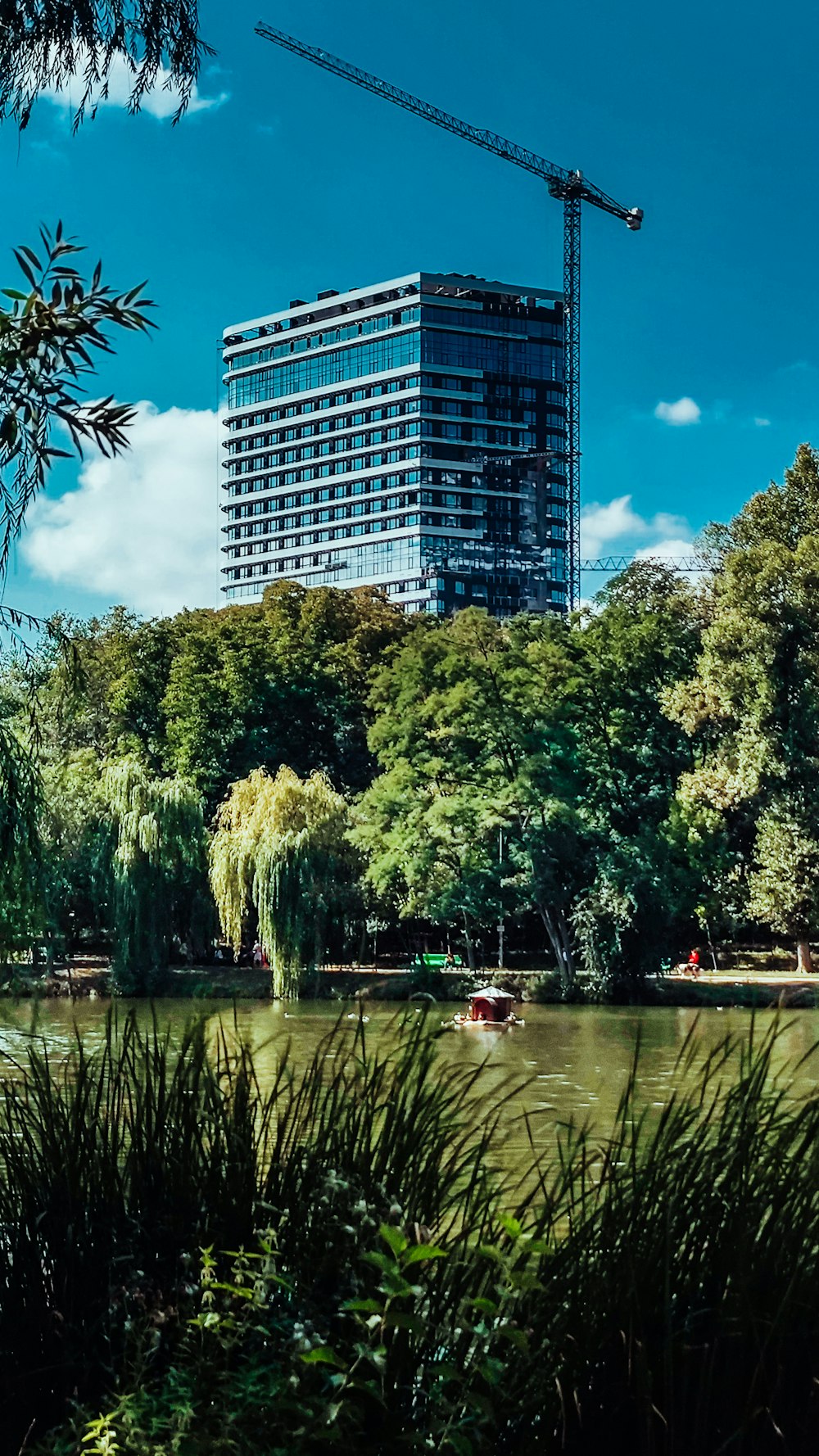 a crane is in the sky over a lake