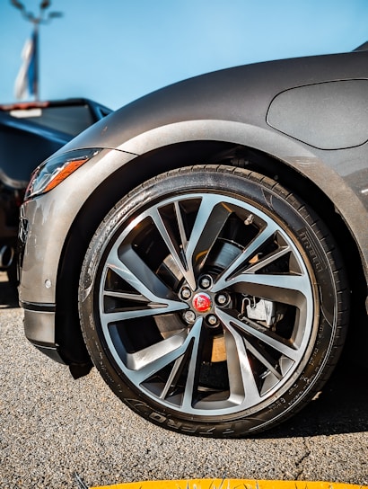 A close-up shot of shiny alloy wheels and branded tyres stacked neatly in the FCA Alloys & Tyres showroom.