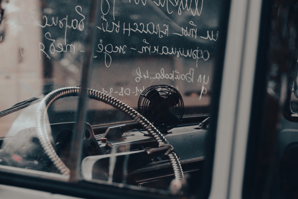 a close up of a car window with writing on it