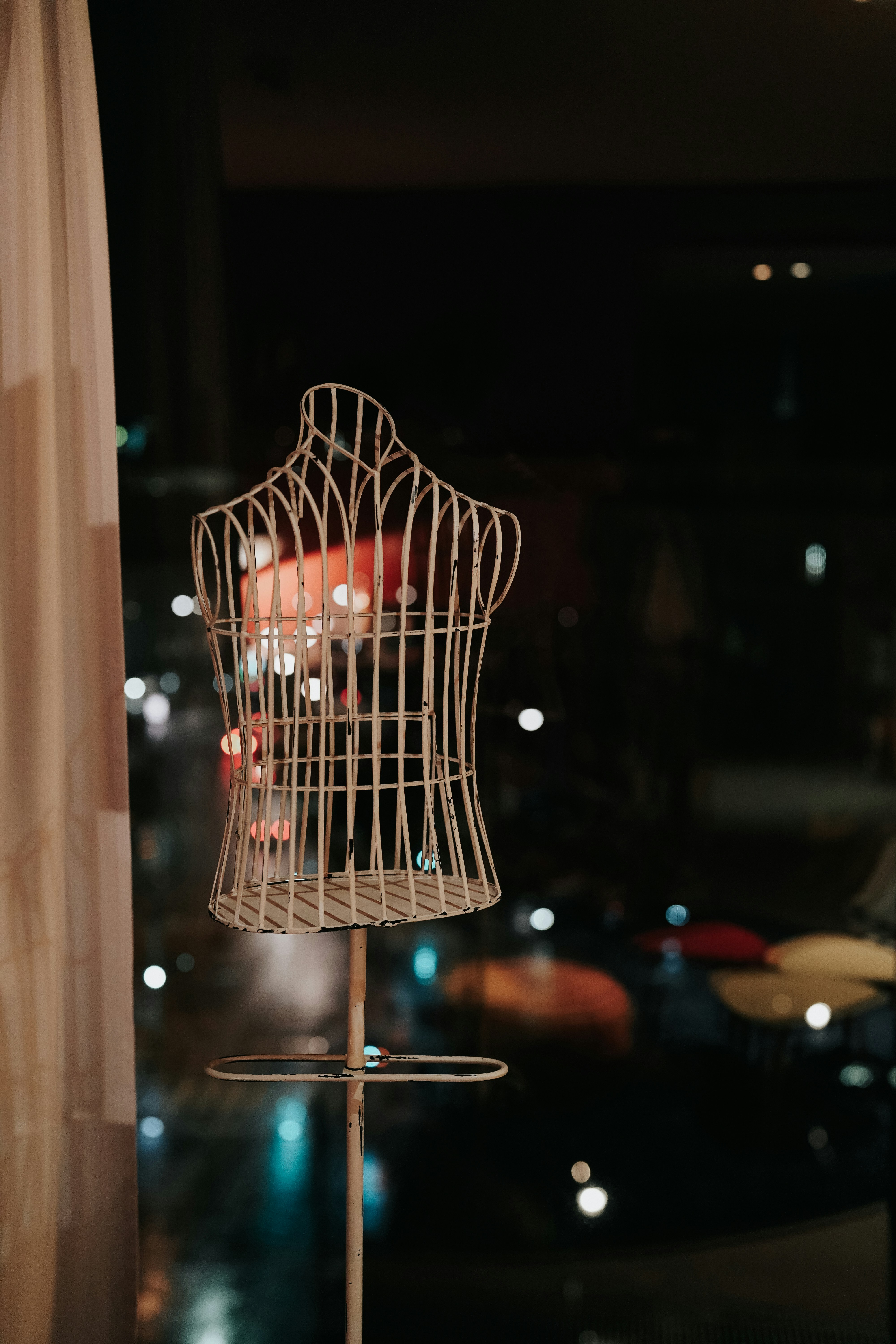 a mannequin is on a stand in front of a window