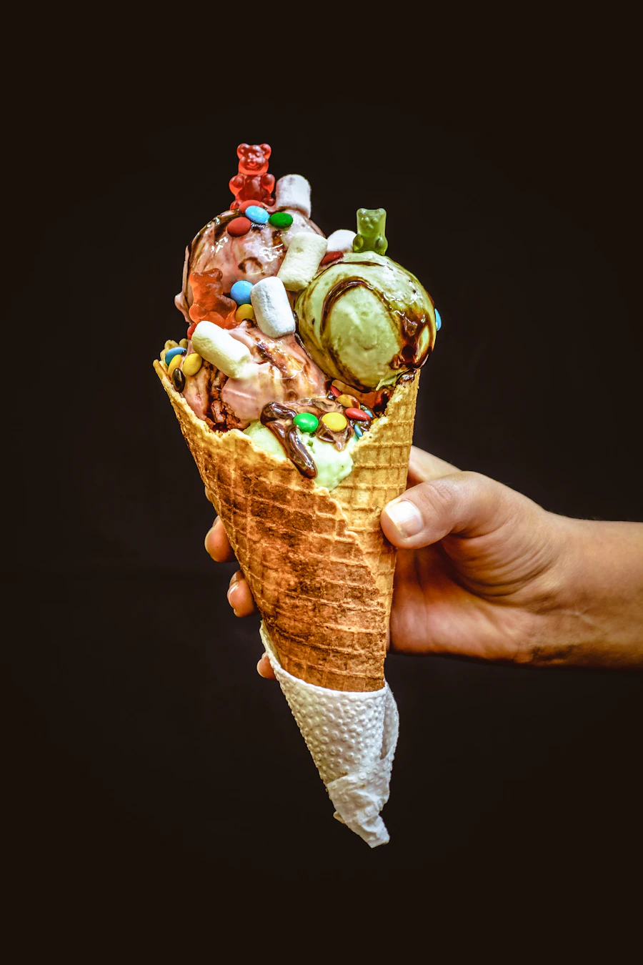 A loaded ice cream cone held up