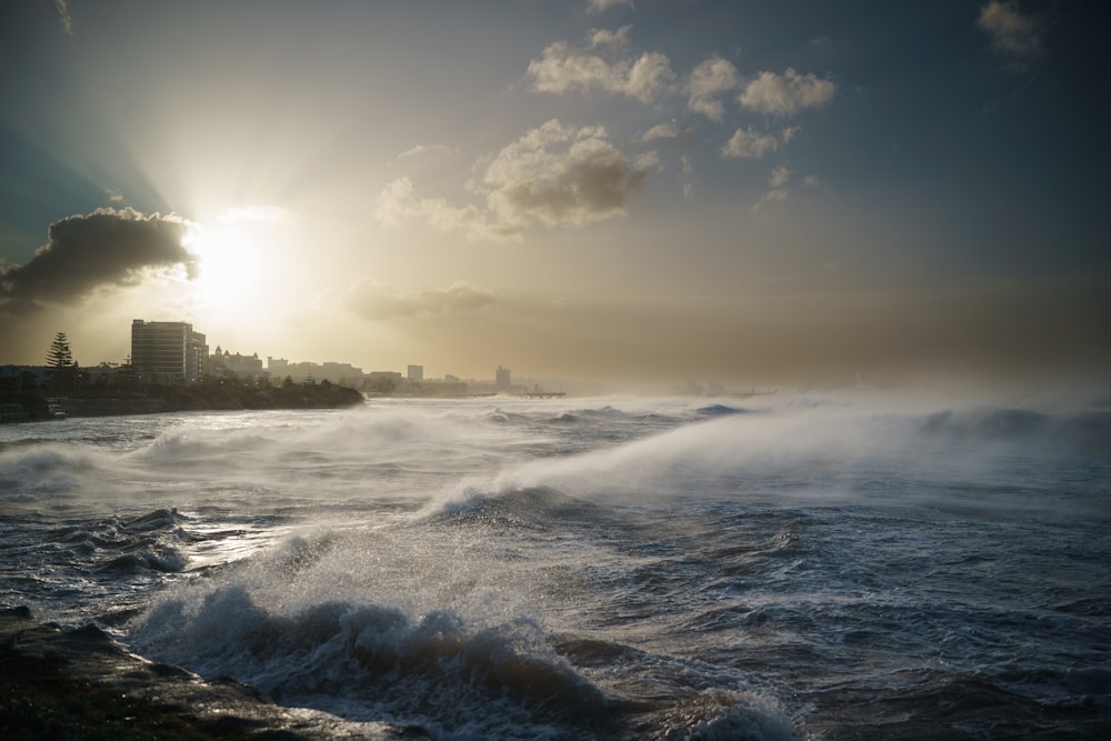 a large body of water with a city in the background