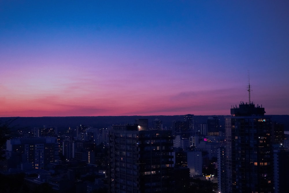 uma vista de uma cidade à noite de um arranha-céus