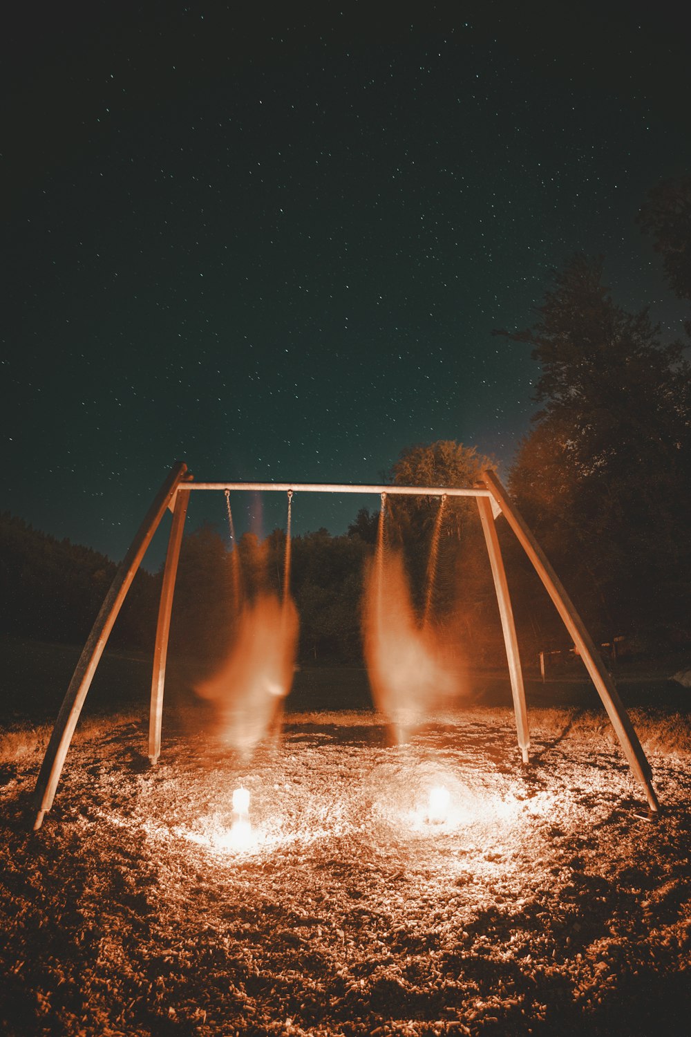 a fire pit in the middle of a field at night