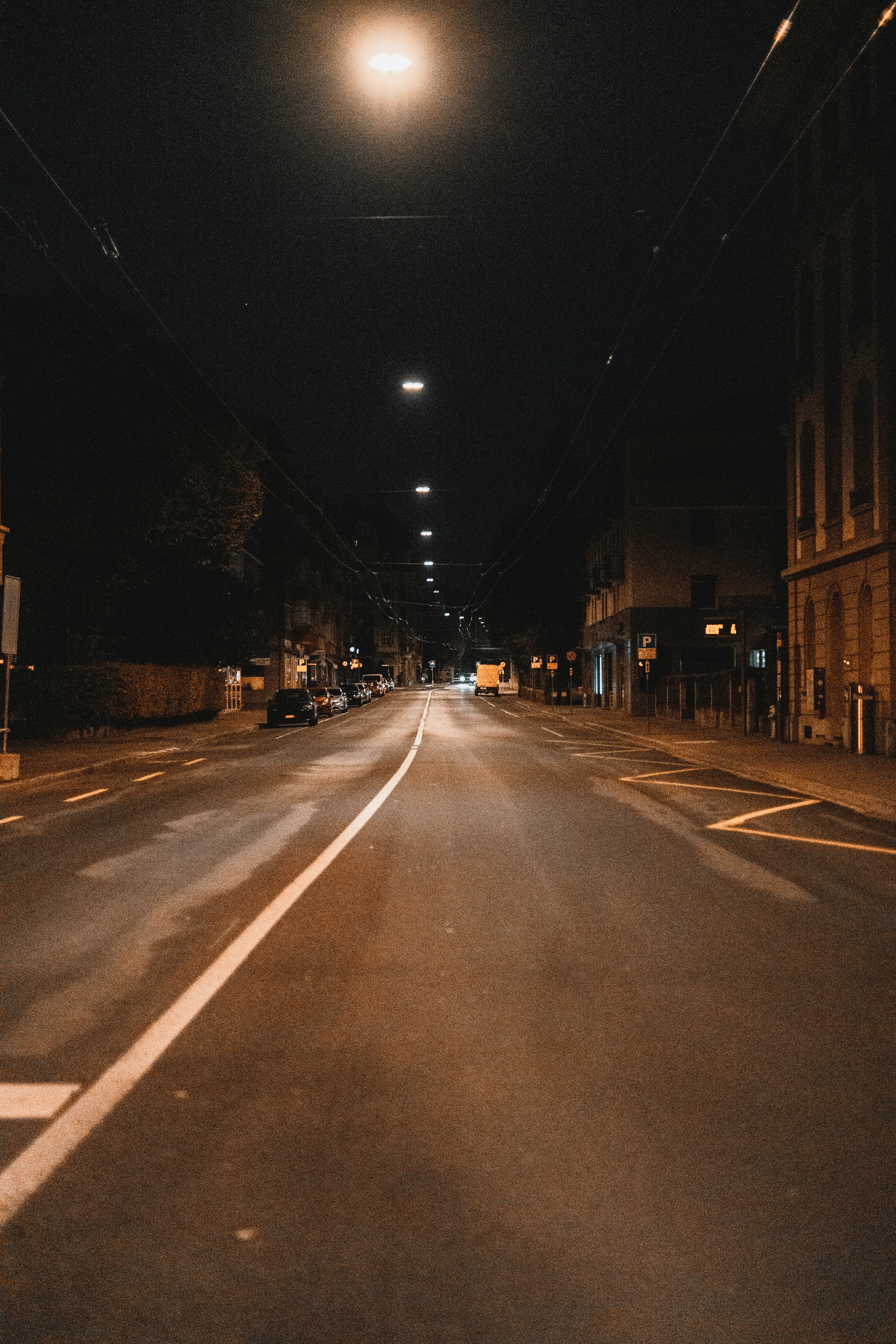 an empty street at night with no cars on it