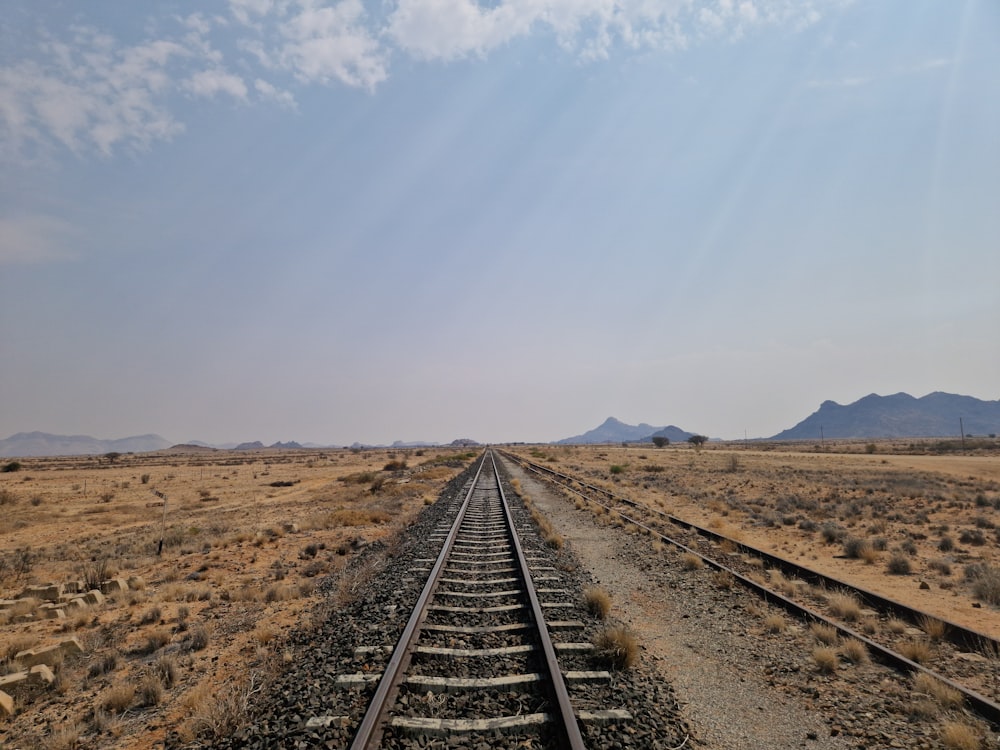 a train track in the middle of a desert