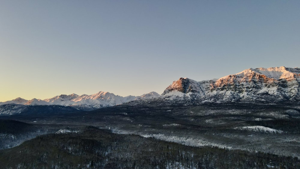 a mountain range with snow covered mountains in the background