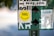 A collection of stickers and signs are attached to a surface, featuring a prominent yellow circular sticker with 'VHS is Happiness' written on it. Other elements include a white sticker advertising sustainable dog treats, a logo for a clothing company called 'way.vee,' and silhouettes of a person walking a dog.