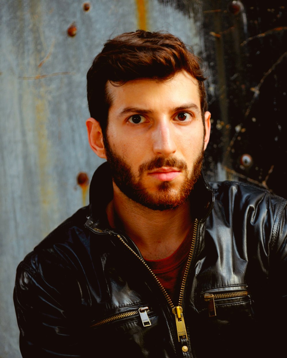 a man with a beard and a leather jacket