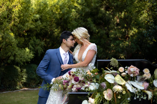 Bride Adrianna and groom Lucas sharing a tender moment, surrounded by bridesmaids in powder blue dresses.