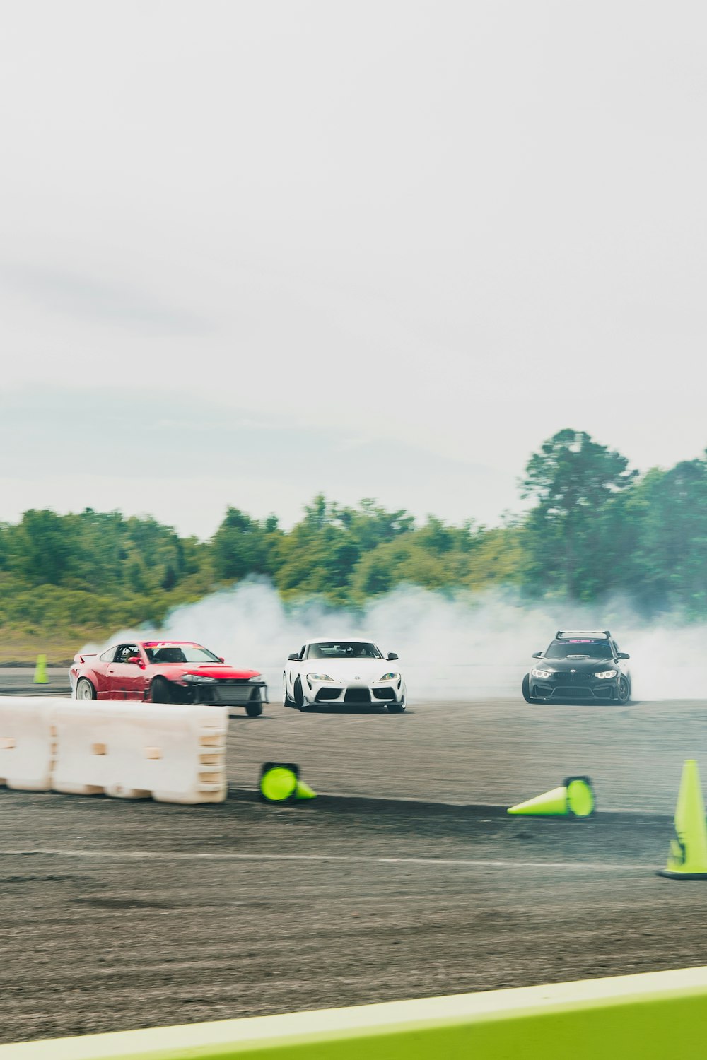 a group of cars driving around a track