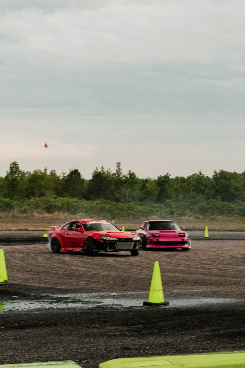 a couple of cars that are sitting in the dirt