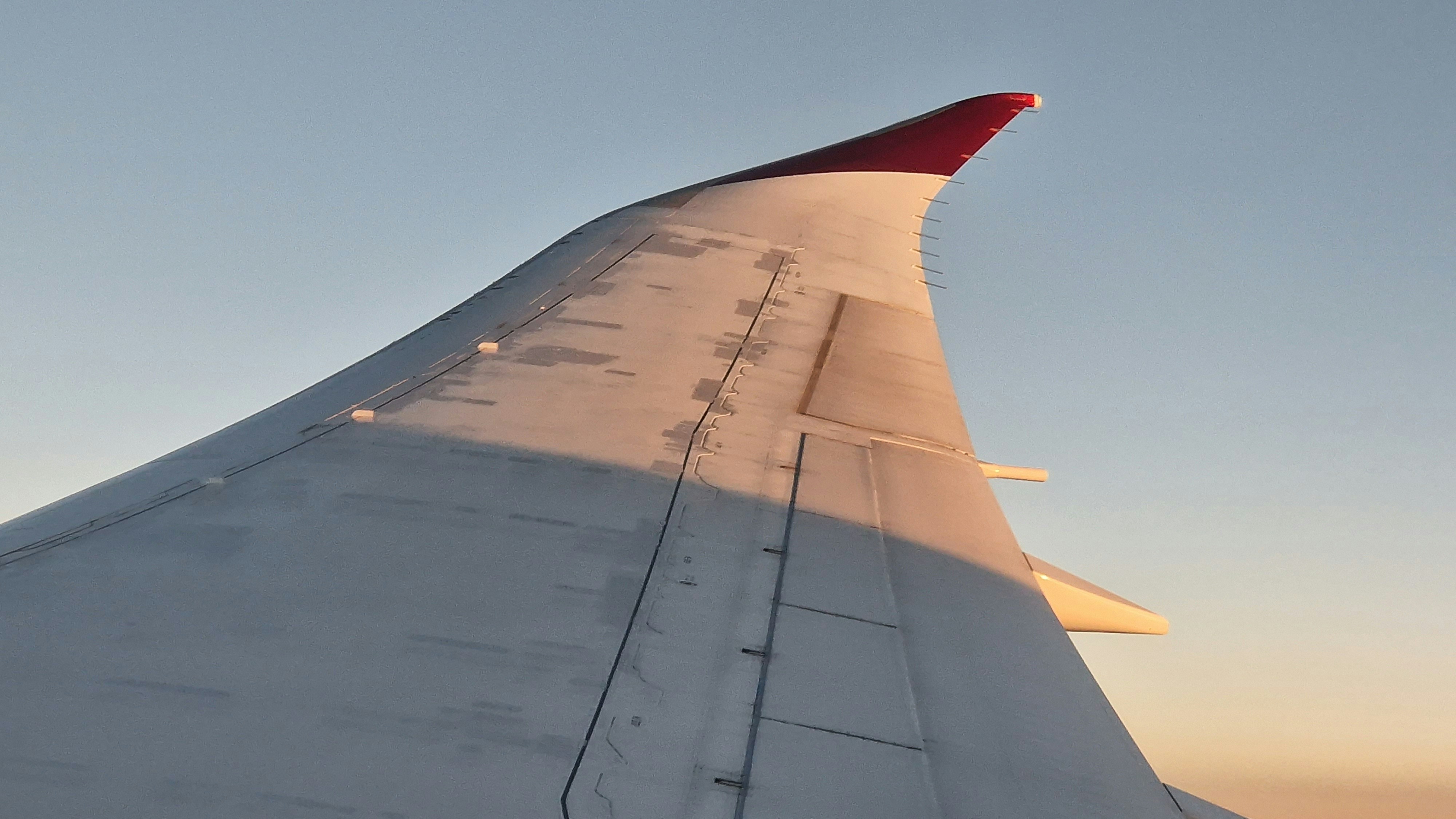 a view of the wing of an airplane in the sky