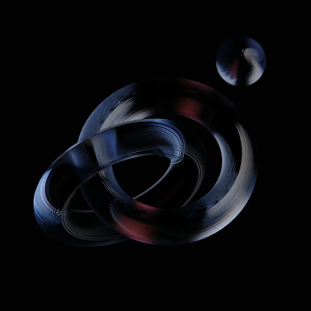 a black background with two circular objects in the middle