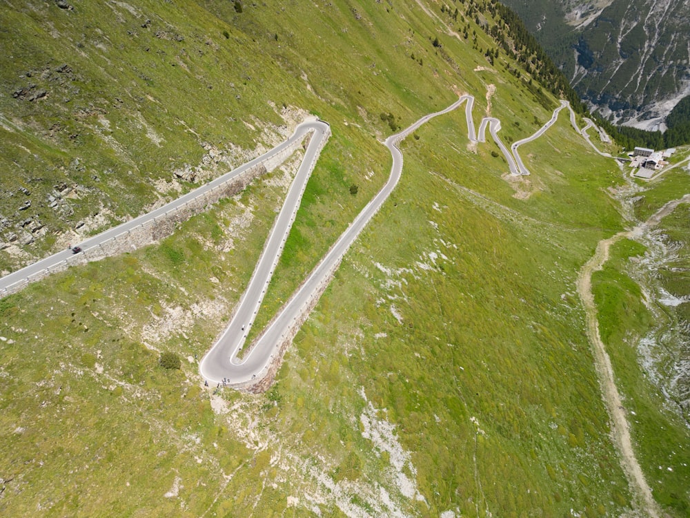 an aerial view of a winding road in the mountains