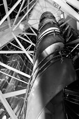 Wide shot of a spiral metal staircase winding upwards in a commercial building.