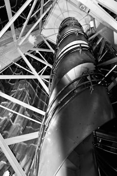 Wide shot of a spiral metal staircase winding upwards in a commercial building.