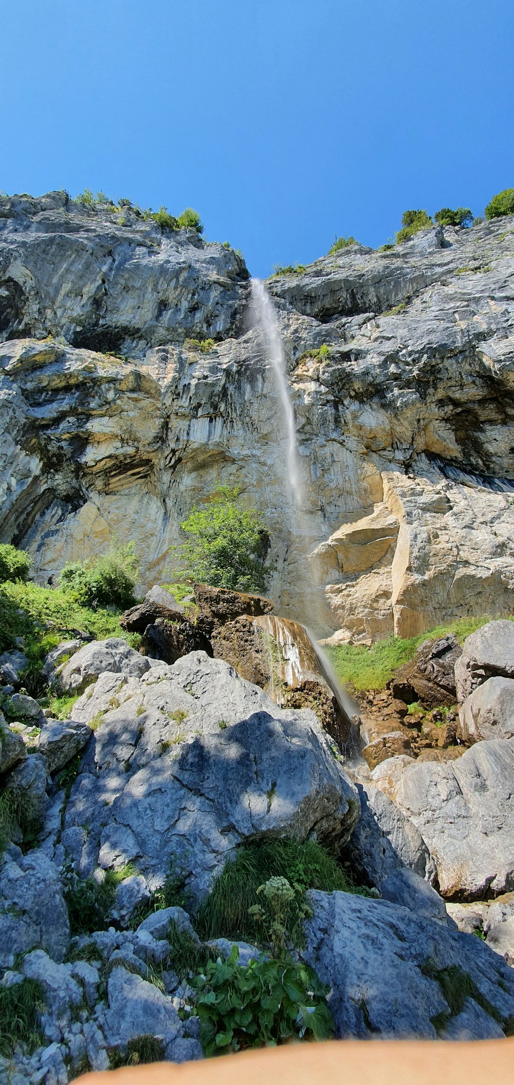 a small waterfall is coming out of the side of a mountain