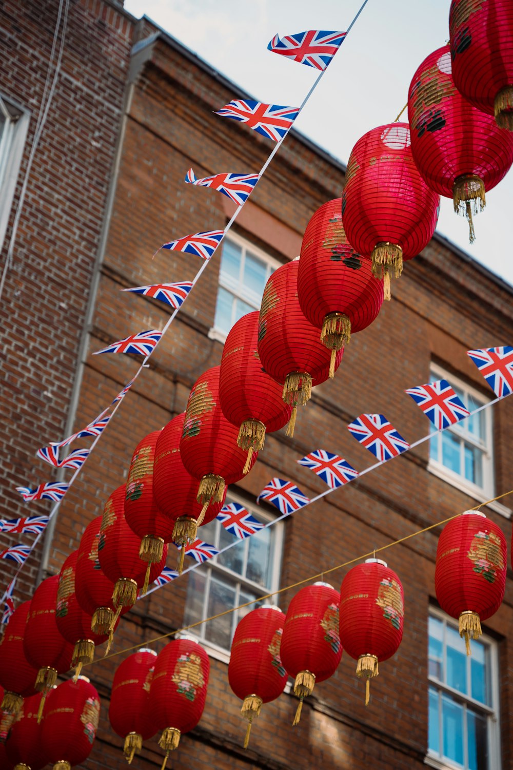 a bunch of red lanterns hanging from a string